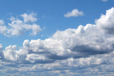 White fluffy clouds on a background of blue sky in summer. The concept of weather and climate.の写真素材