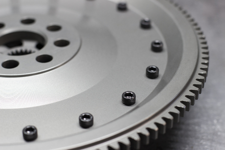 A new set of replacement automotive clutch on a metal background. Disc and clutch basket with release bearingの写真素材
