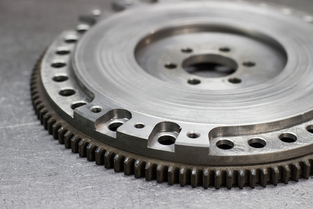 Set to replace the automobile clutch (composed of damping flywheel, drive and basket) on a metal backgroundの写真素材