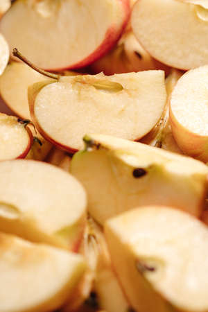 Sliced apples fruit. Vertical macro view of many slices of cut applesの写真素材