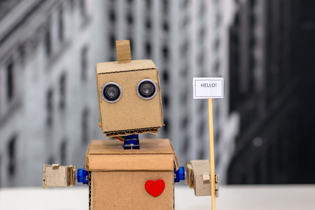 robot hands holding a plate with the inscriptionの写真素材