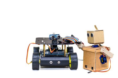 two robots standing together on a white backgroundの写真素材