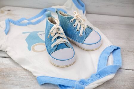 children's clothing for boys and shoes on a wooden backgroundの写真素材