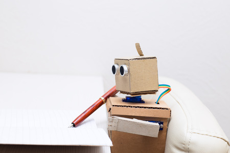 Robot writes a pen in a notebookの写真素材