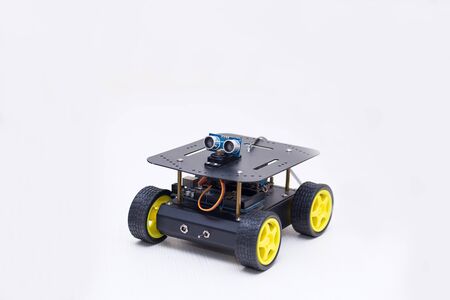 metal robot on wheels on white background