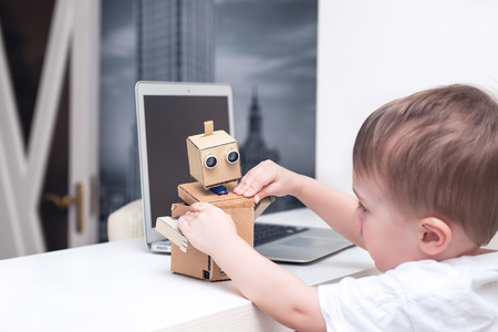 boy plays with the robot homeの写真素材