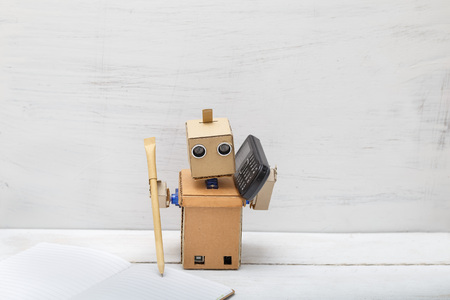 Robot holding a pen writing in diaries and talking on the phone. Artificial Intelligenceの写真素材