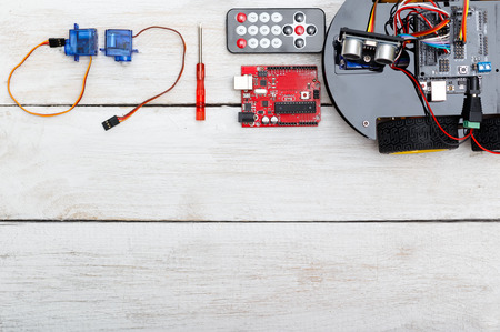robot on wheels and elements necessary for the robot assembly. PCB, Servo Screwdriver