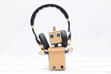 Artificial Intelligence. Robot in golden headphones on a light backgroundの写真素材