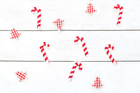 Christmas background. Christmas toys and candy canes on a white wooden background