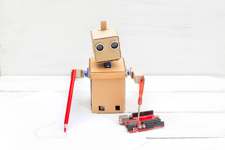 Robot does two things at the same time, draws and repairsの写真素材