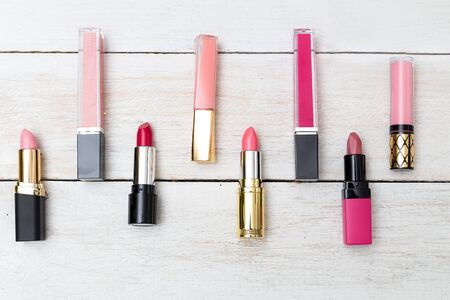 Lipstick and gloss on a wooden background.  Flatlayの写真素材