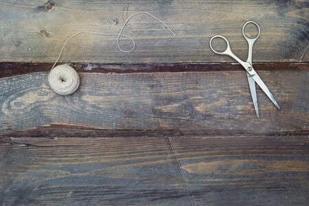 Accessories for handmade sewing on wooden background. Copy spaceの写真素材
