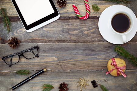 Desk with a digital tablet and christmas decoration. Mock upの写真素材