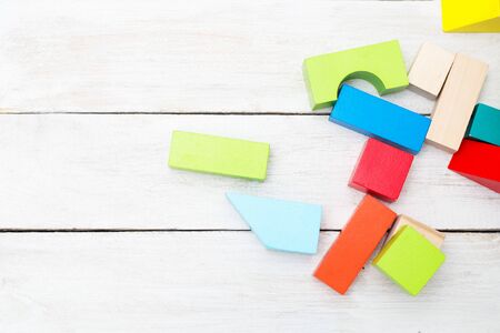 Developing wooden multicolored cubes on a wooden background. Copy spaceの写真素材