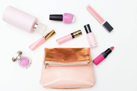 Cosmetics and cosmetic bag of pink color on a white background. Flat layの写真素材