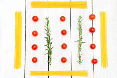 Food knolling. Spaghetti and vegetables on a white wooden boardsの写真素材