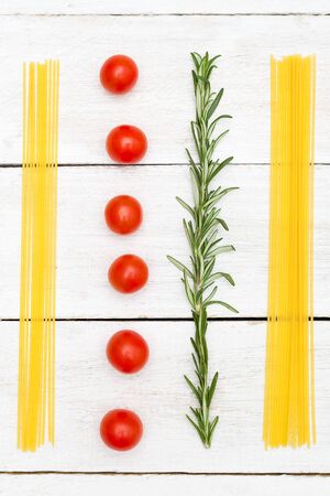 Food knolling vertical. Spaghetti and vegetables on a white wooden backgroundの写真素材