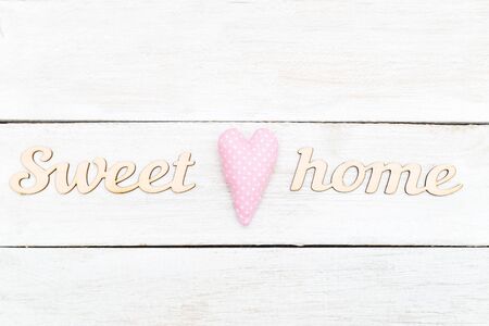 Wooden letters  sweet home on a wooden background. Minimalist designの写真素材