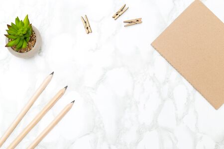 Diary for notes and pencils on a marble background background. Desk minimalist styleの写真素材