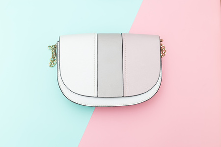 Women's handbag on two pastel color background. Flat layの写真素材