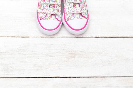 Fashionable shoes for little girls on white wooden  background. Flat layの写真素材