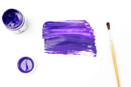 Ultra violet paint smear and brush on white paper. Art flat layの写真素材