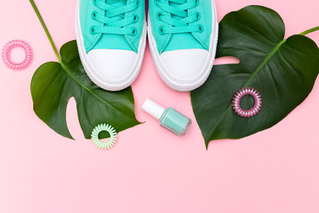 Monstera and pair of green canvas. Trendy fashion woman accessoriesの写真素材