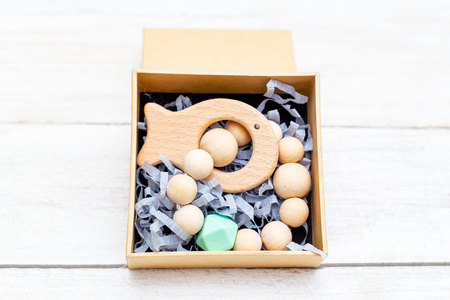 Baby wooden teether on wooden  background
