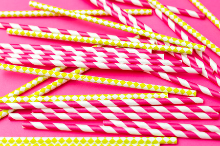 Bright green and bright pink paper tubes on a bright pink background. Zero wasteの写真素材
