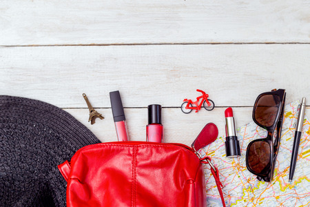 Travel feminine accessories on wooden background. copy space