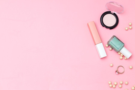 Ring and make up on pink background. Copy spaceの写真素材