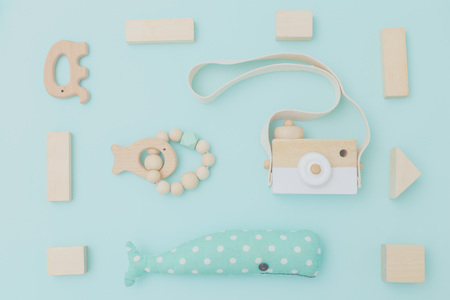 Organic wooden toys on blue background. Toys background