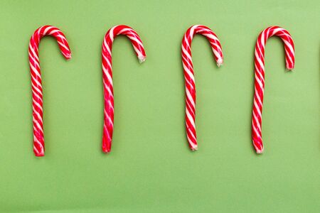 Christmas candy cane on green background. Christmas time