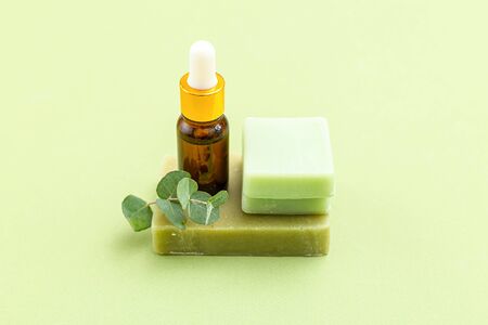 Soap, eucalyptus and serum on green backgriund. Skin care. Minimalismの写真素材