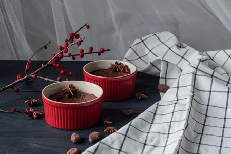Hot chocolate fondant with berries and cocoa beans on dark backgroundの写真素材