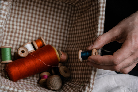 Craftsman choosing threads to work with.の写真素材