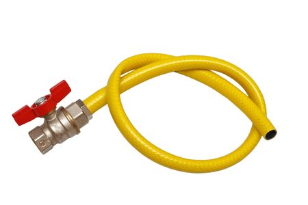 Tap water and yellow rubber hose on a white background (isolated).の写真素材