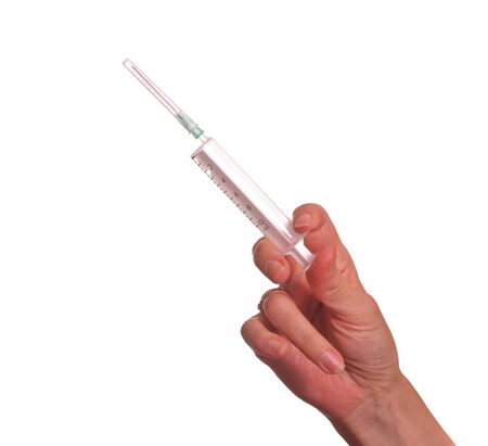 Medical syringe in hand a nurse (isolated).の写真素材