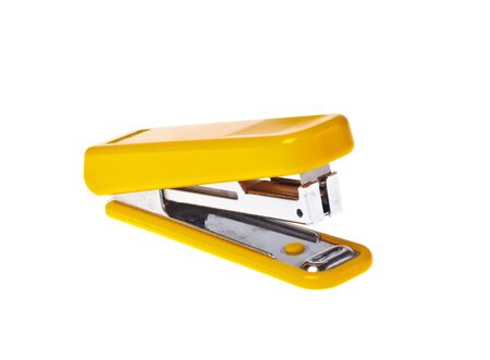 Yellow  stapler on a white background close-up (isolated).の写真素材