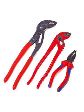 Alligator wrenches and pliers on white background close-up (isolated).の写真素材