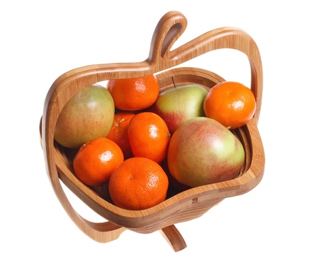 Tangerines and apples in a wooden basket isolated on a white background.の写真素材