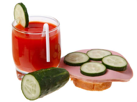 A glass of tomato juice and sausage sandwich isolated on white background.の写真素材