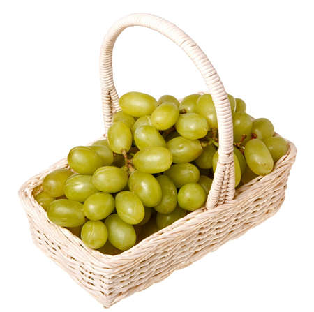 Fresh grapes in a basket isolated on white background の写真素材