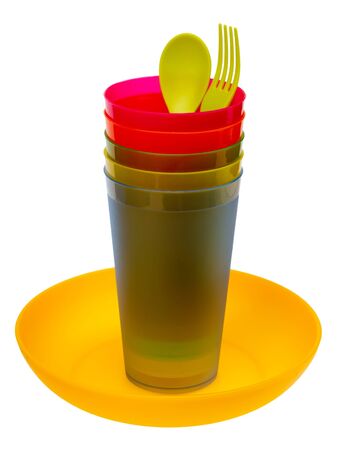 Plastic plate, multicolored glasses, spoon and fork, isolated on a white background の写真素材