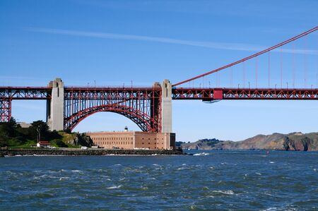 Fort Point and Golden Gate Bridge fragment under blue skies on a nice windy spring day. Lansdcape (horizontal) orientation.の写真素材