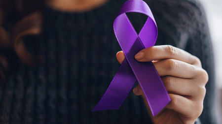 woman holds a purple awareness ribbon close upの素材