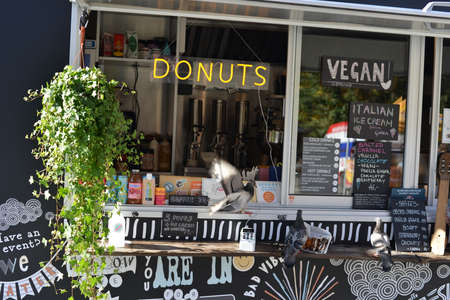 Oslo.Oslo/Norway-09.09.2020: Pigeons eating doughnuts outside Donuts food truck in Oslo.のeditorial素材