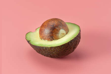 Avocado fruit on a pink backgroundの写真素材