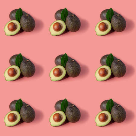 Fresh ripe avocados on a pink background. Fruit pattern.の写真素材